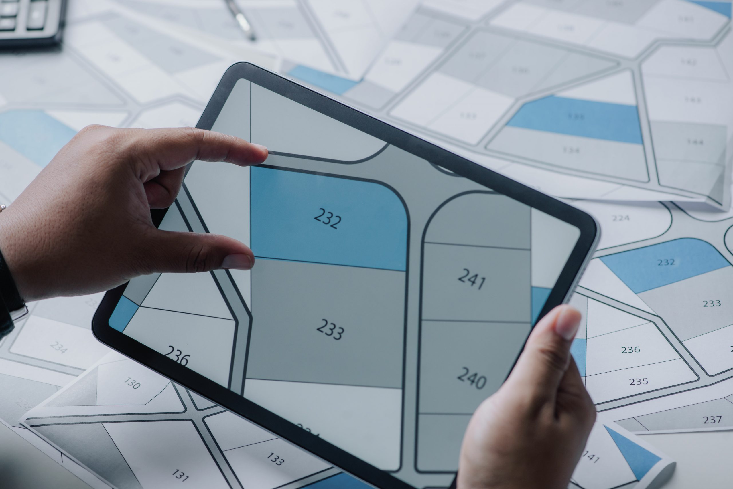 Man searching building plot to buy on cadastral plan for house c